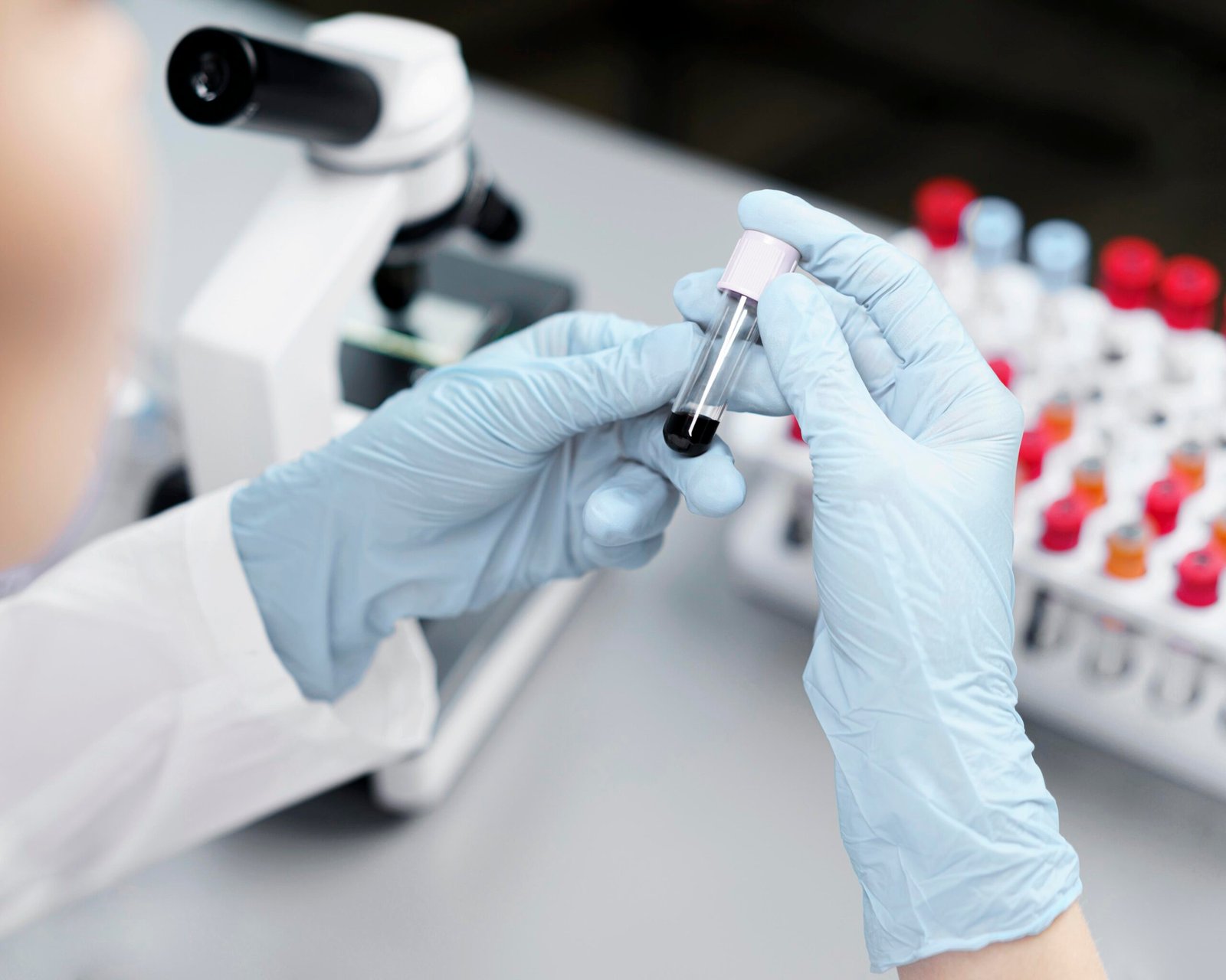 high-angle-female-researcher-laboratory-with-test-tubes